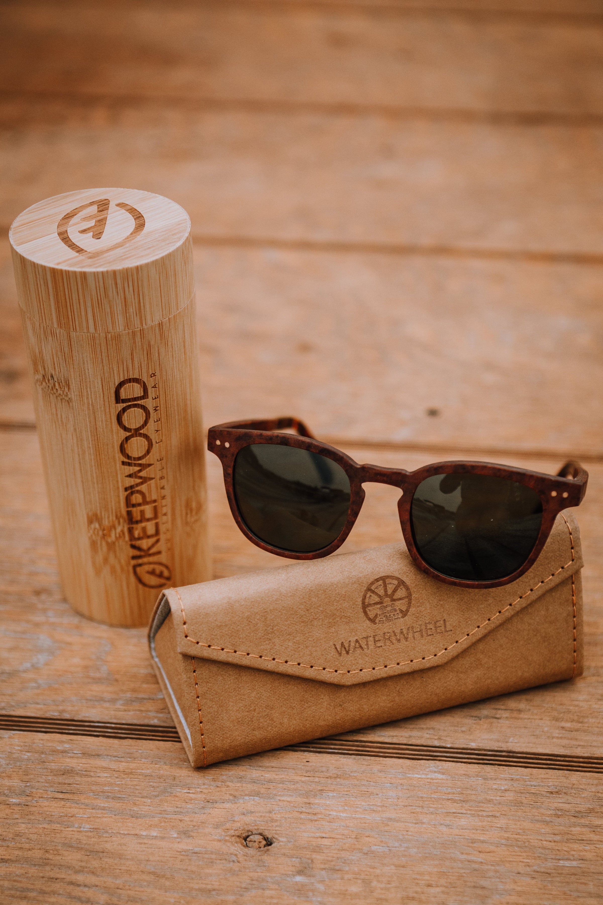 Langley wood sunglasses resting on bamboo case on wooden dock