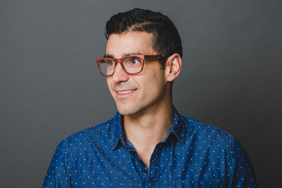 Man looking to his right, wearing red Keepwood eyeglasses.