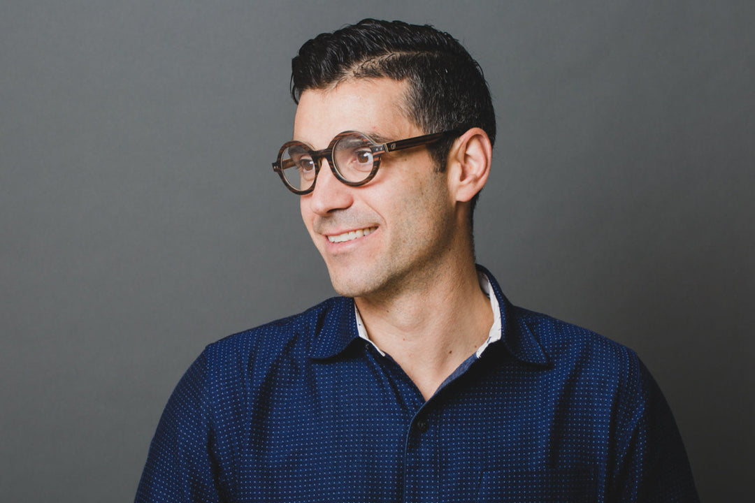 man wearing round black wood eyeglasses