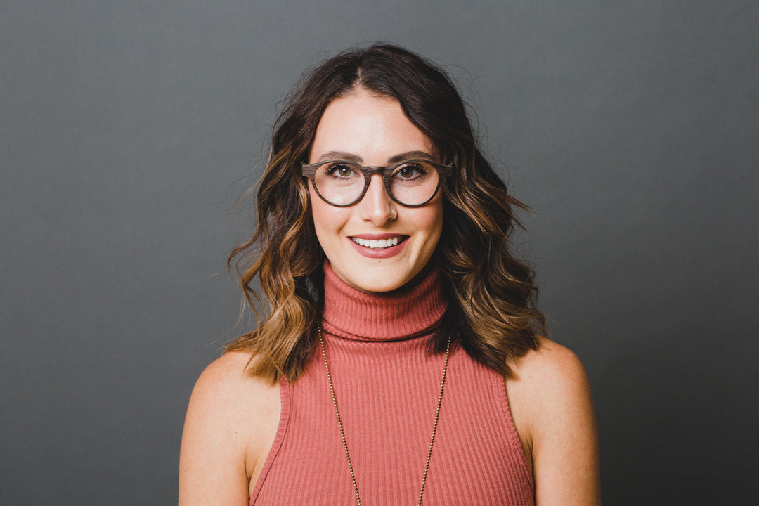 woman wearing black oak glasses.