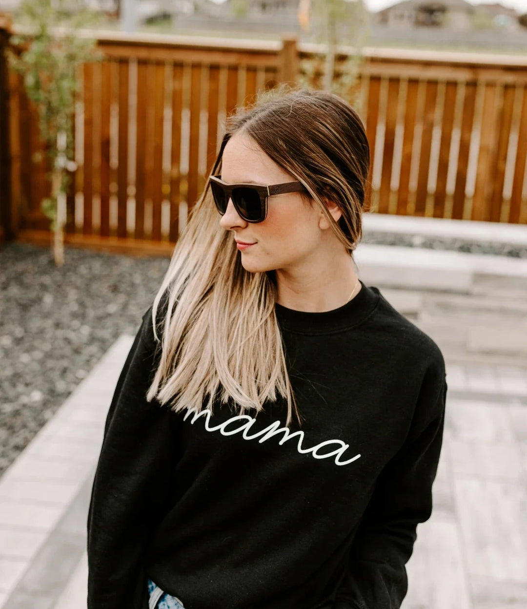 woman wearing black oak wood sunglasses. 