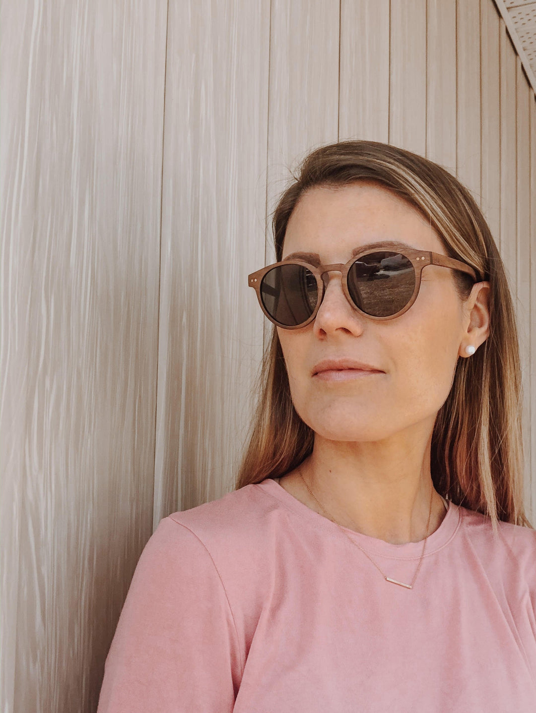 woman wearing walnut wood sunglasses